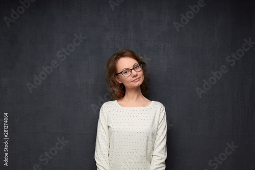 Portrait of calm girl with glasses looking kindly at camera © Andrei Korzhyts