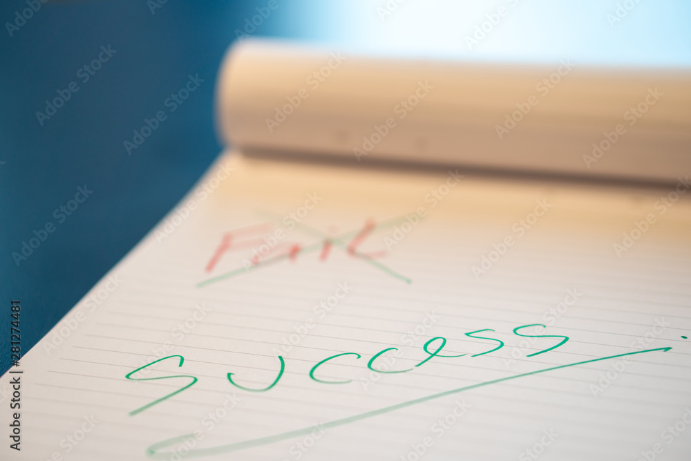 Fild text with a hand with a red pen And crossed out with a green pen on the notebook. Success message by hand with a green pen below the fail. The concept of not giving up on failure. Fild text with a hand with a red pen And crossed out with a green pen on the notebook. Success message by hand with a green pen below the fail. The concept of not giving up on failure.