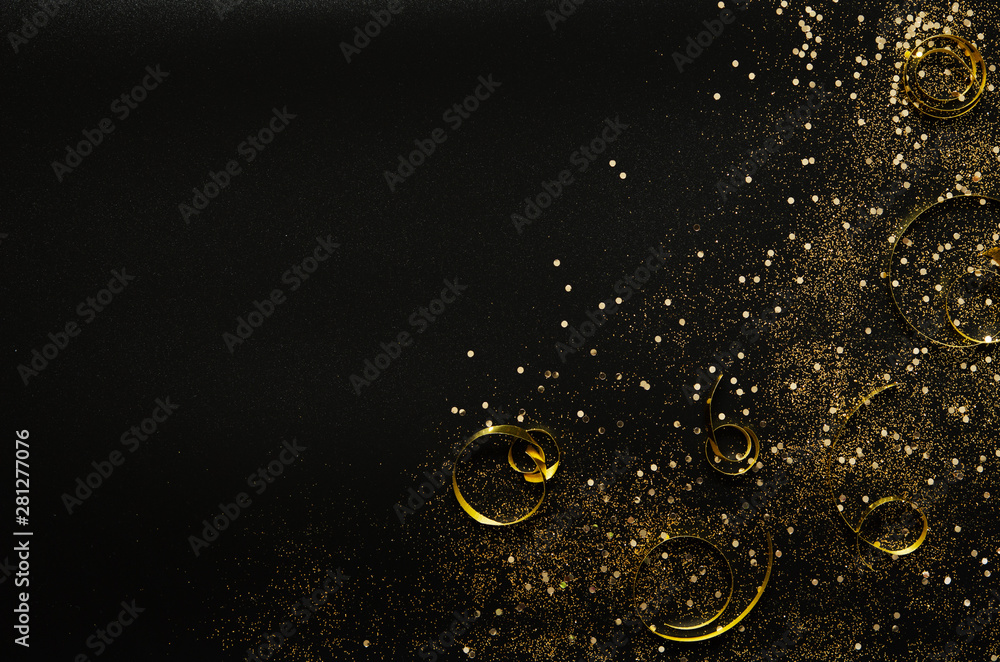 Golden sparkles and ribbons on black background. Festive concept. - Image - obrazy, fototapety, plakaty 