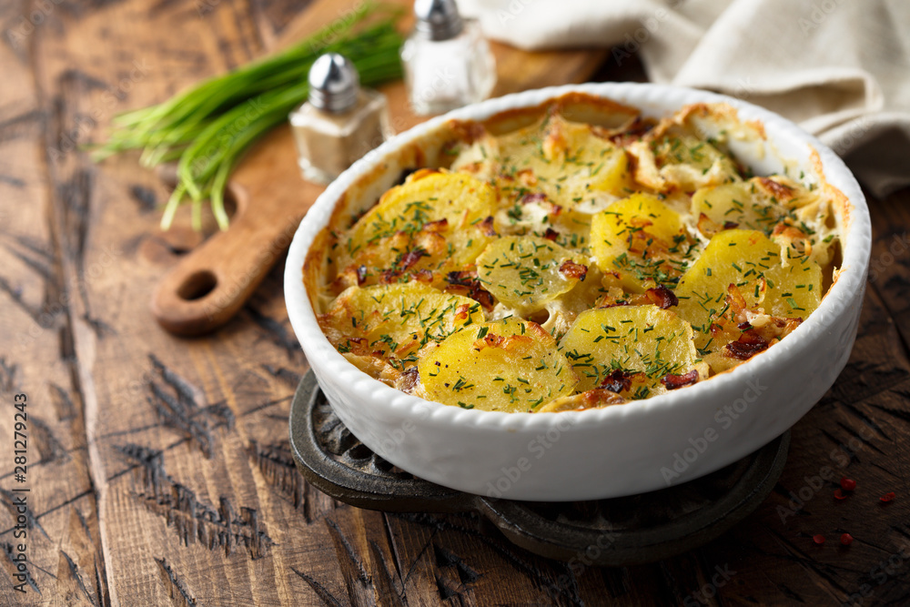 Homemade potato gratin with bacon and herbs Homemade potato gratin with bacon and herbs
