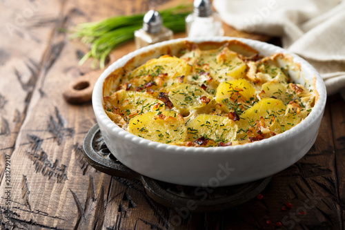 Homemade potato gratin with bacon and herbs