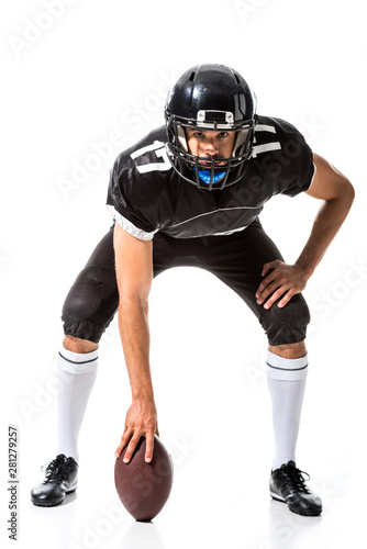 American Football player holding ball and looking at camera Isolated On White