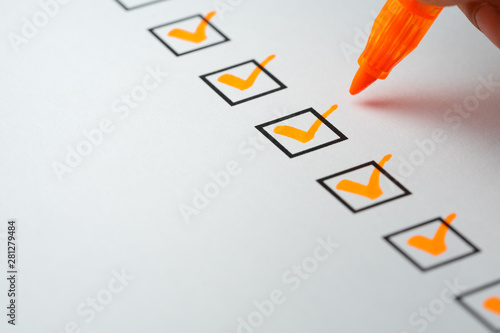 Orange marking on checklist box with pen, Checklist concept