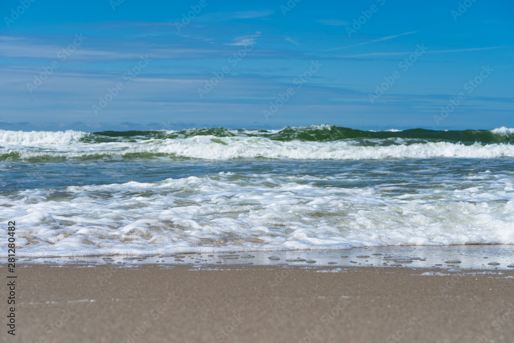 Seaside. A wave is coming. Small grains of sand close up. Concept. Background. Summer is over. Summer sales. Free space for text. Seaside. A wave is coming. Small grains of sand close up. Concept. Background. Summer is over. Summer sales. Free space for text.