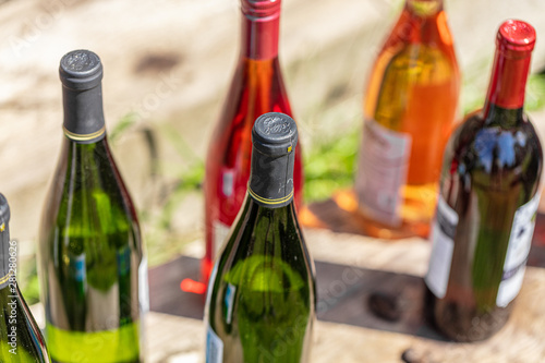 Wine Bottles sitting on railroad tie in park