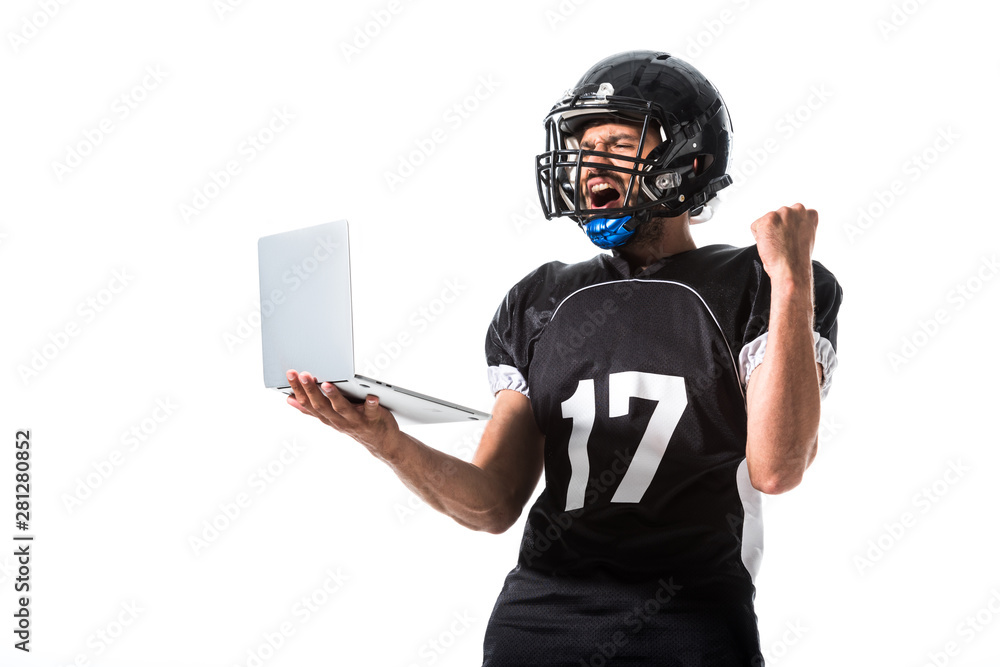 American Football player with laptop cheering with clenched hand Isolated On White