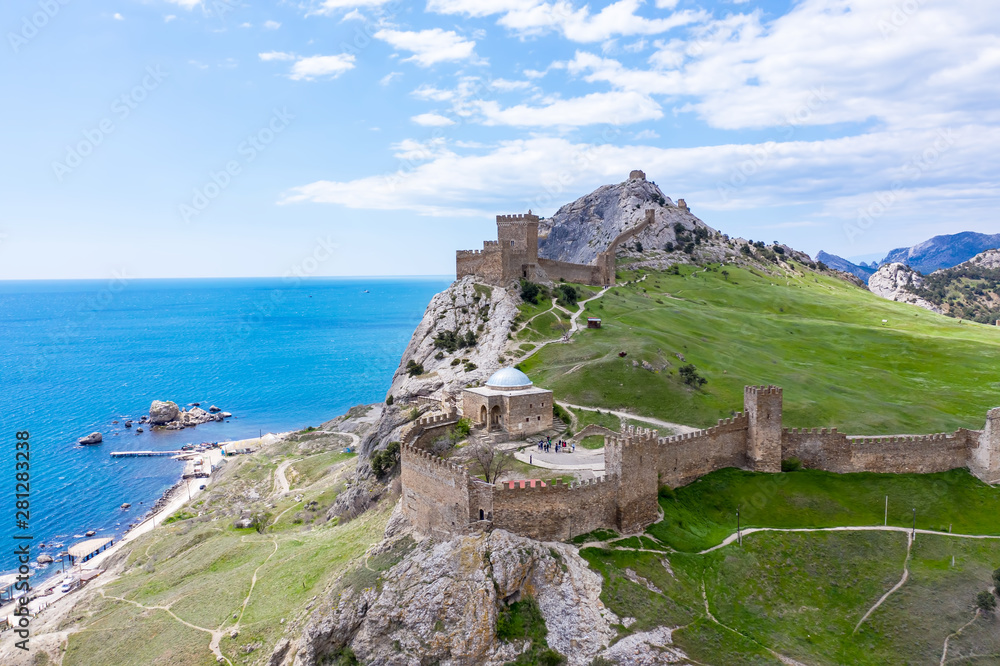 Genoese fortress in the Sudak bay on the Peninsula of Crimea. Aerial drone view