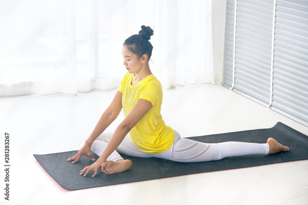 Skinny asian woman wear yellow sport t-shirt practice yoga exercises Skinny asian woman wear yellow sport t-shirt practice yoga exercises