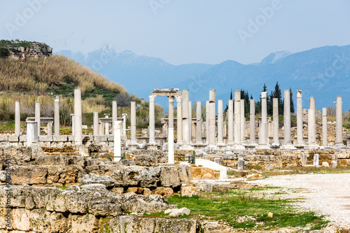Ruin of marble columns on a background of mountains in the Ancient city of Perge near Antalya, Turkey