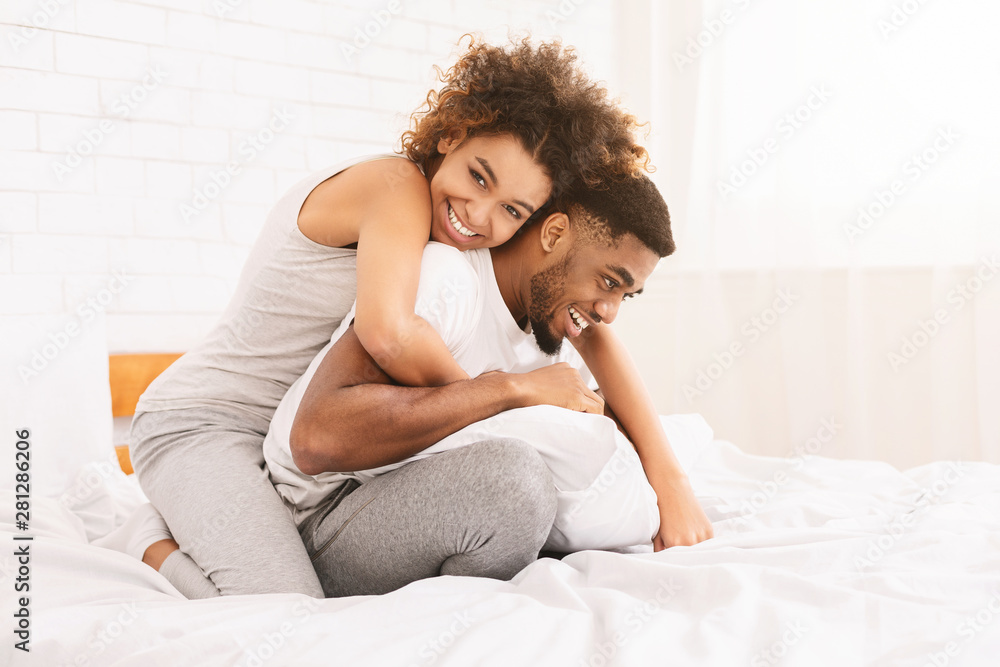 Young loving couple having romantic times in bedroom Young loving couple having romantic times in bedroom