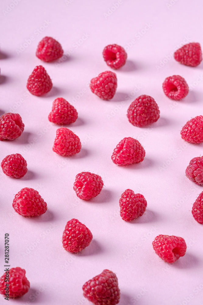 Raspberry sweet organic juicy berries, pattern, texture, on pink paper background Raspberry sweet organic juicy berries, pattern, texture, on pink paper background