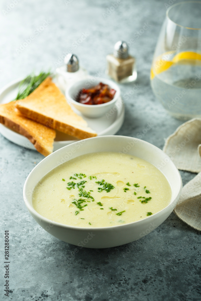 Homemade creamy asparagus soup in a white bowl Homemade creamy asparagus soup in a white bowl