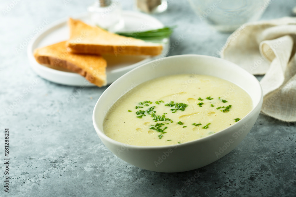 Homemade creamy asparagus soup in a white bowl Homemade creamy asparagus soup in a white bowl