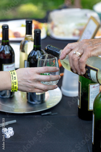 opening a bottle of wine and pouring into glass