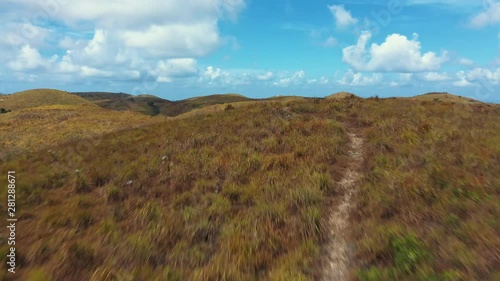 Trekking Path Way Teletubbies Hill. Drone Shot Tropical Savanna Hills at Nusa Penida, Bali - Indonesia photo