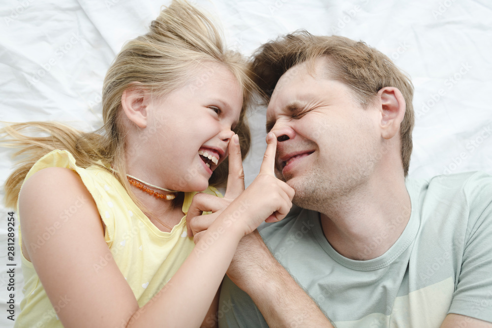 Father happy smiling daughter in bed Father happy smiling daughter in bed