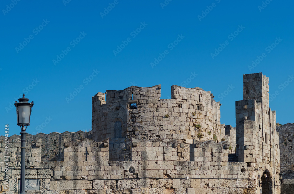 Medieval fortress under blue summer sky in Rhodes, Greece.