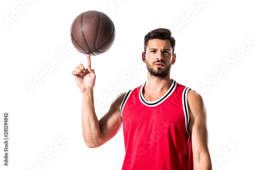 basketball player spinning on finger ball and looking at camera Isolated On White