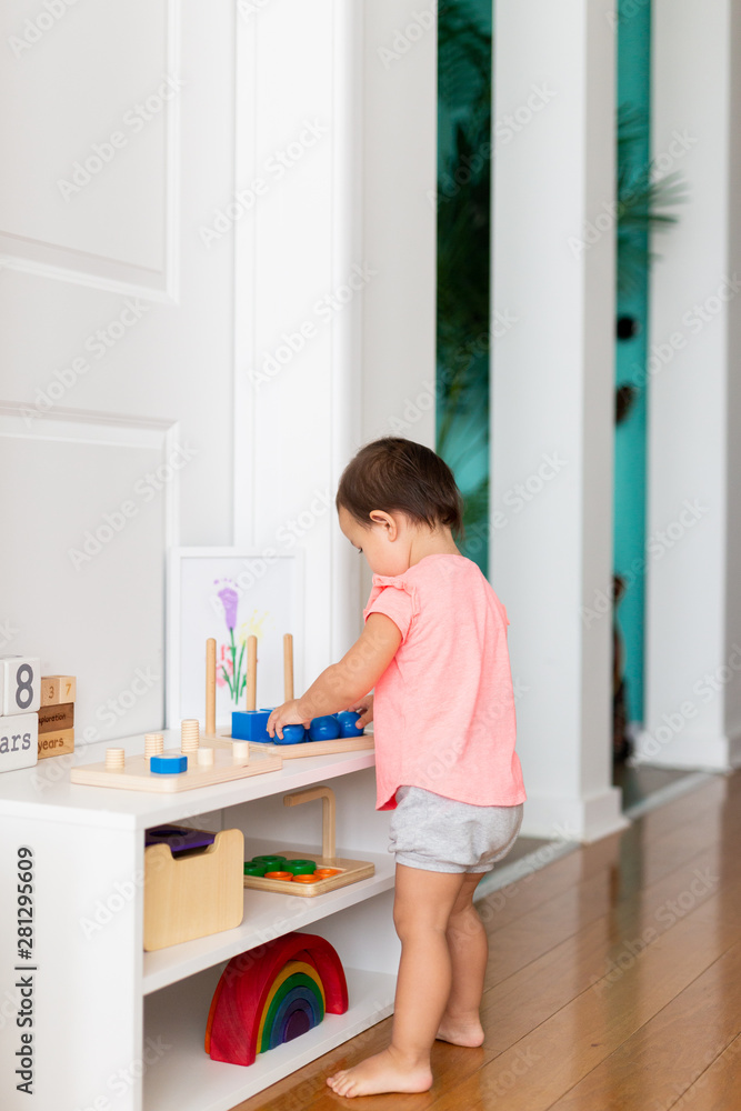 Toddler Girl Playing and Exploring with Montessori Lessons Toddler Girl Playing and Exploring with Montessori Lessons