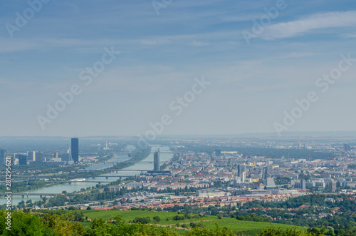 City top view of Vienna with buildings, street and river through a tourist camera