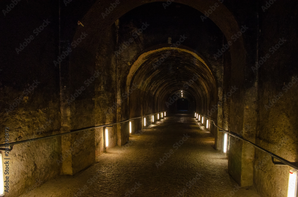 Dark spooky underground alley of european vintage building