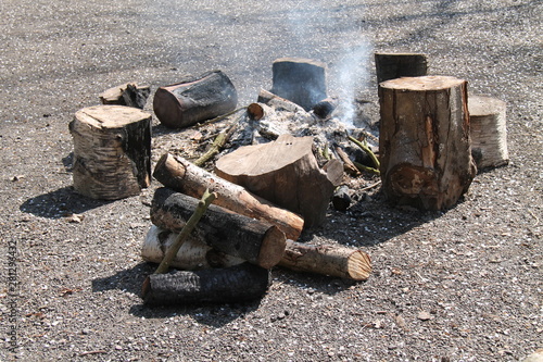 A Gently Smouldering Large Outdoor Wood Log Fire.