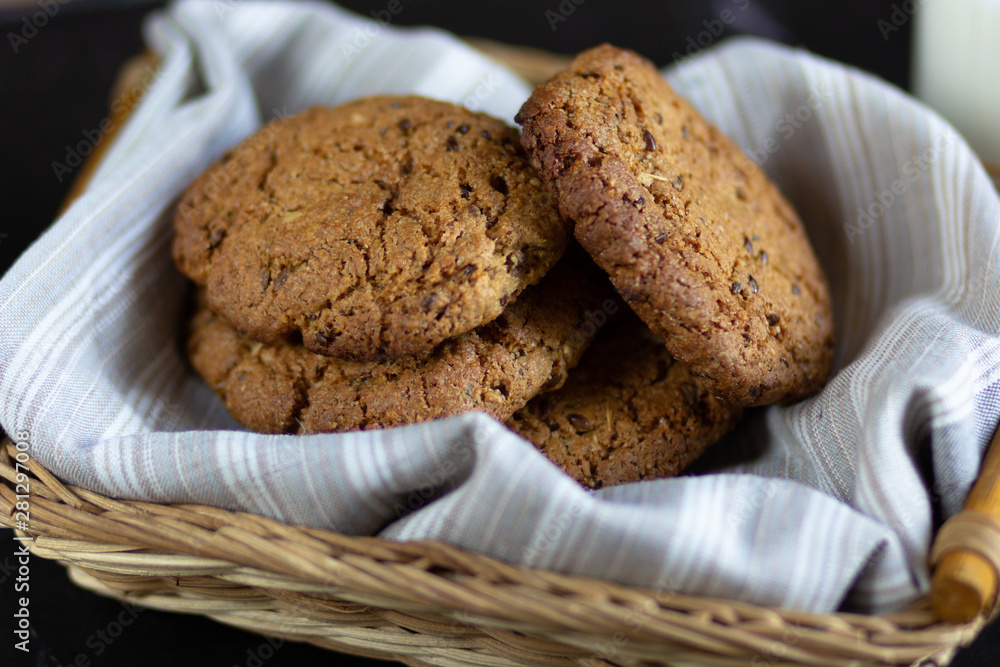 Homemade oatmeal cookies in basket with linen napkin Homemade oatmeal cookies in basket with linen napkin