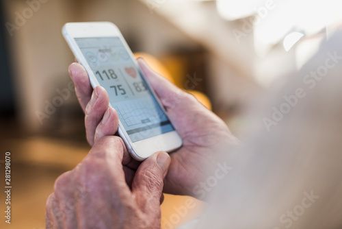 Wallpaper Mural Senior man using smart phone app Torontodigital.ca