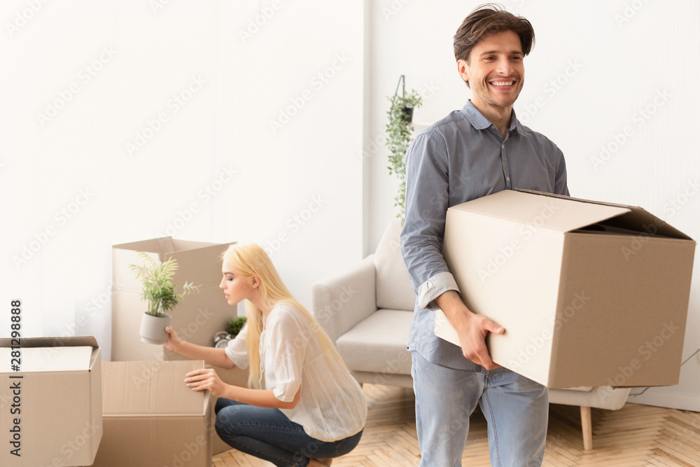 Household Move. Happy Couple Packing Stuff In Boxes Household Move. Happy Couple Packing Stuff In Boxes