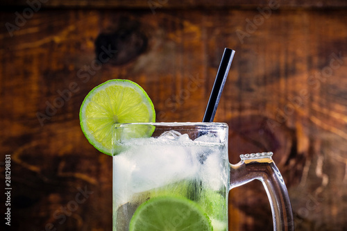 Beer caipirinha. Brazilian exotic drink of beer with lemon and cachaça. photo