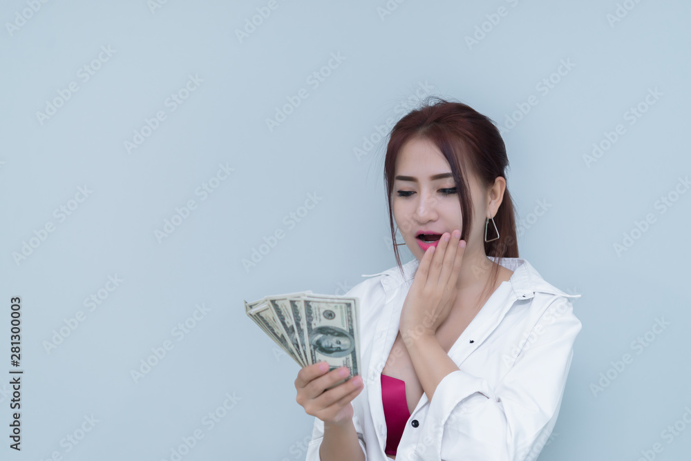 Portrait of asian sexy woman with a lot of money on white background,thailand people,The rich business woman concept Portrait of asian sexy woman with a lot of money on white background,thailand people,The rich business woman concept