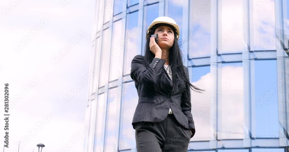 Happiness businesswoman calling by phone on the business architecture background. Concept of: Skyscraper, Business girl, Architect, Lifestyle. Happiness businesswoman calling by phone on the business architecture background. Concept of: Skyscraper, Business girl, Architect, Lifestyle.