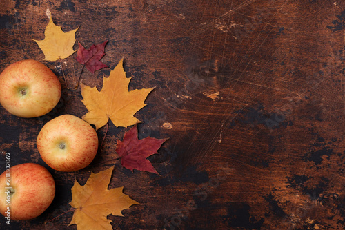 Apple and yellow red maple leaves old grunge wooden background Back to school concept Season school theme Flat lay, top view, copy space