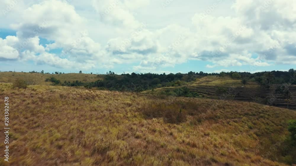 Dramatic Drone Shot Close to Ground of Teletubbies Hill. Tropical Savanna Hill at Nusa Penida, Bali - Indonesia Dramatic Drone Shot Close to Ground of Teletubbies Hill. Tropical Savanna Hill at Nusa Penida, Bali - Indonesia