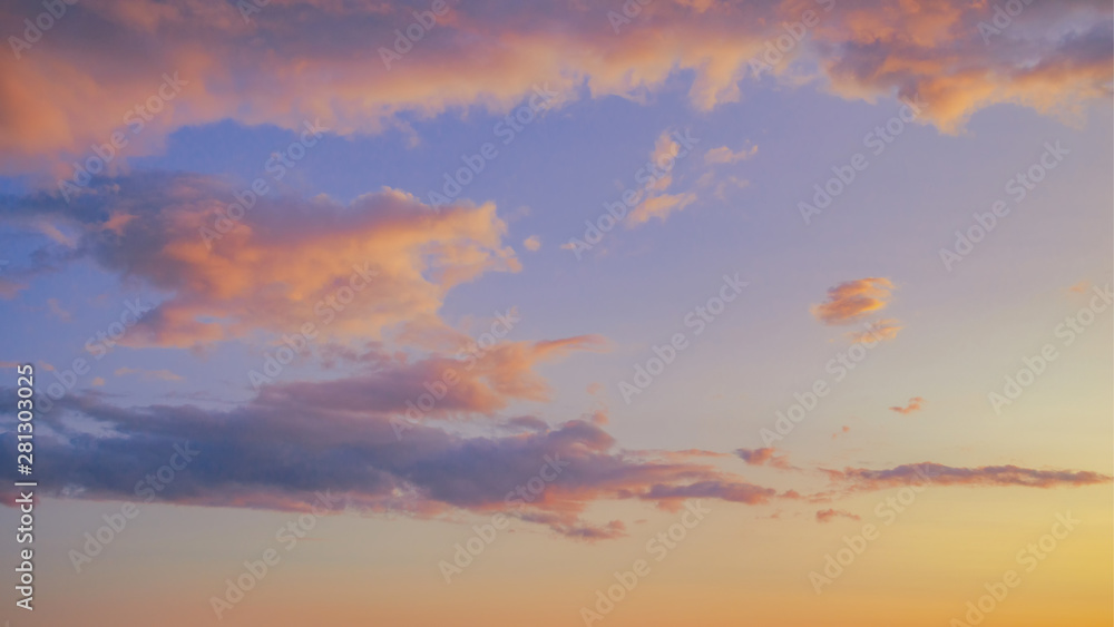 Beautiful twilight sunset sky and cloud at summer background image. New heaven light and earth concept. Dramatic sun ray with blue orange sky and pink purple clouds dawn texture color background.