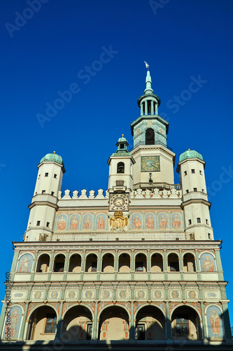 facade of Renaissance town hall with tower clock in Poznan.