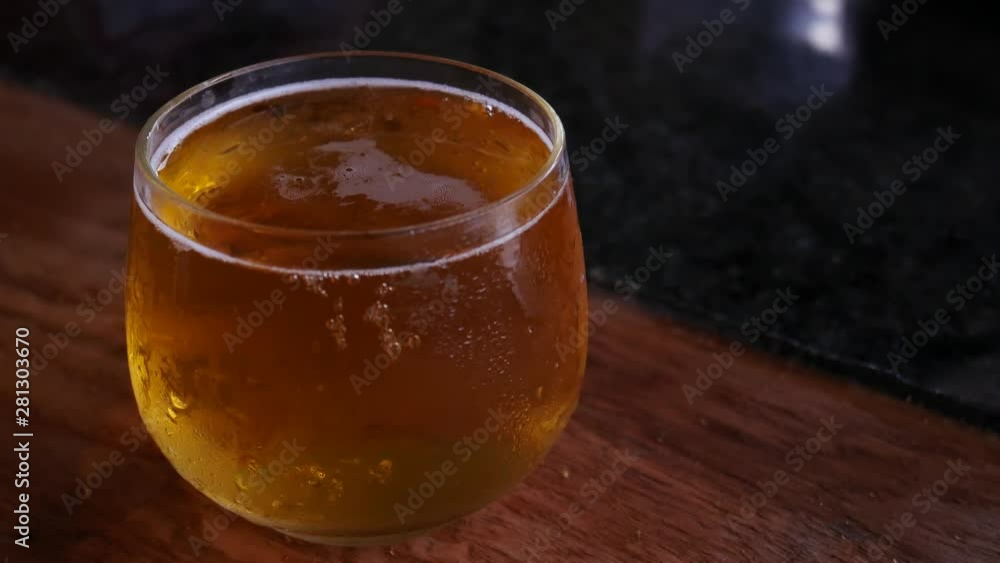 Light beer with rising up air bubbles in a transparent glass. Close up Light beer with rising up air bubbles in a transparent glass. Close up