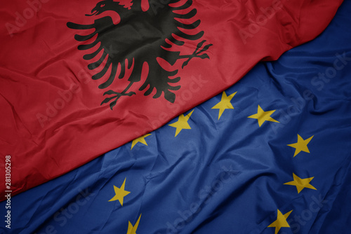 Konstfotografi waving colorful flag of european union and flag of albania.