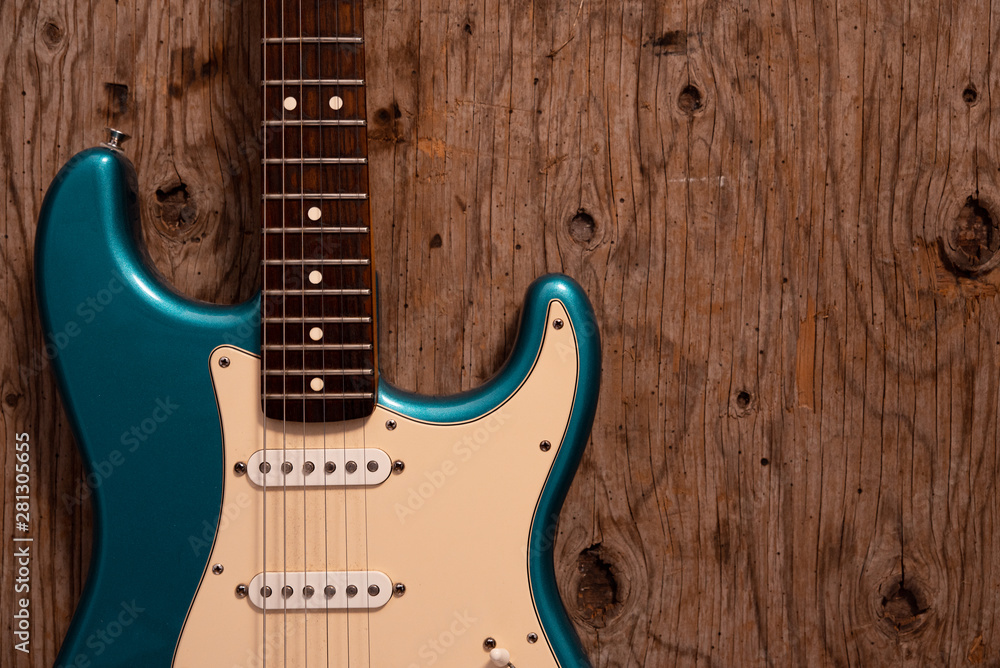 Fototapeta premium Electric guitar on a wooden background.
