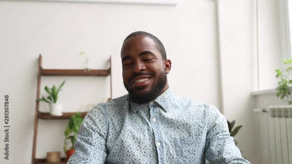 African man talking looking at web cam during job interview