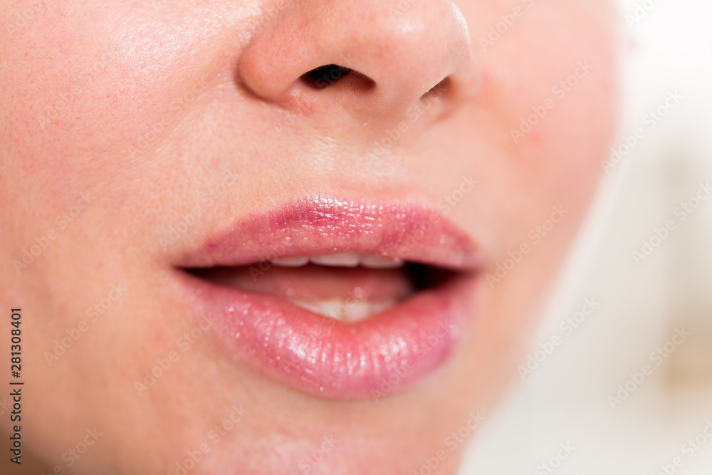 Close-up of female's lips with natural lipstick make up. macro lipgloss make-up