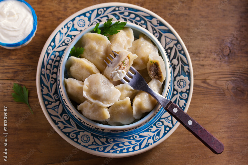 Dumplings stuffed with meat. Pierogi, varenyky, vareniki, pyrohy - dumplings with filling, popular dish in many countries. View from above, top studio shot Dumplings stuffed with meat. Pierogi, varenyky, vareniki, pyrohy - dumplings with filling, popular dish in many countries. View from above, top studio shot