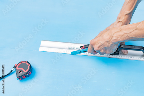 Worker cuts plastic model knife photo