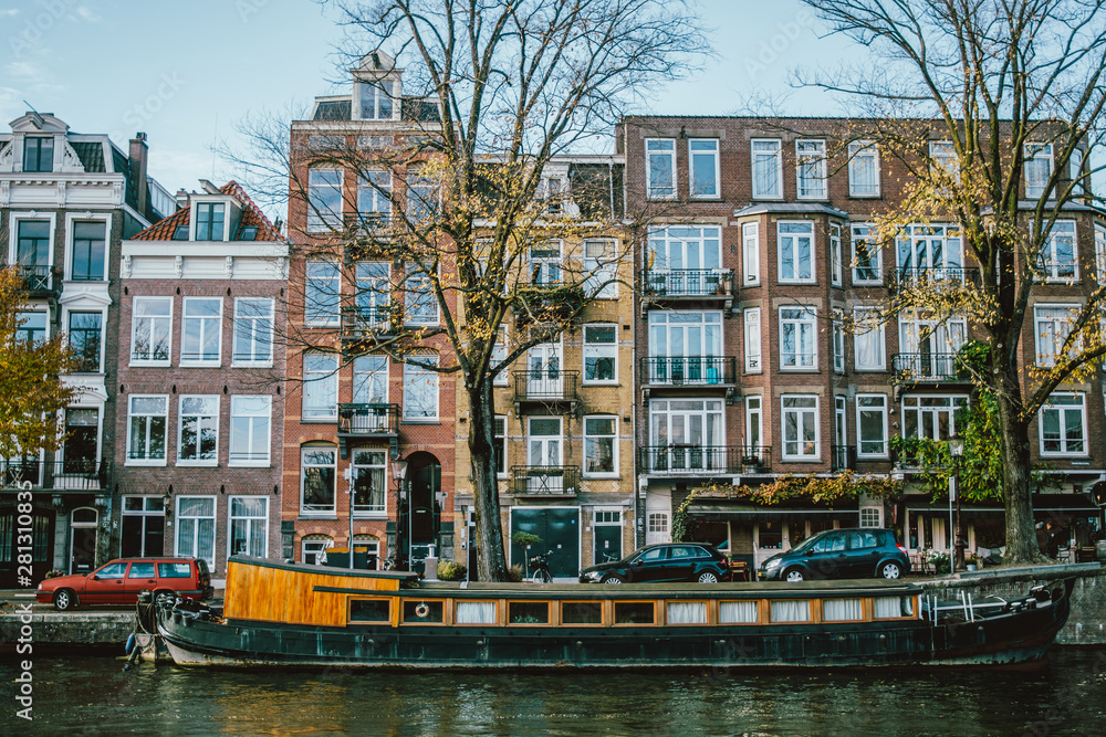 Amsterdam canal with a boat and houses
