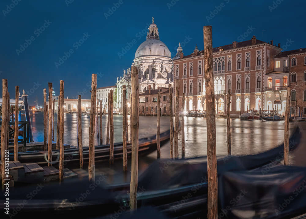 Stunning landscape of Venice at night. Long exposure photo of calm landscape of the city. The Basilica Santa Maria della Salute in background