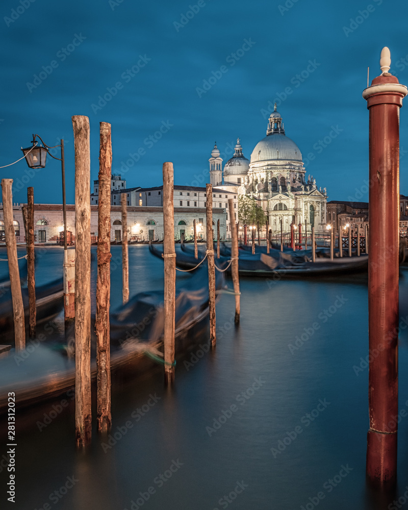 Stunning landscape of Venice at night. Long exposure photo of calm landscape of the city. The Basilica Santa Maria della Salute in background