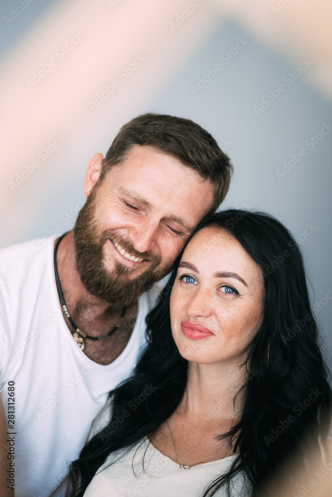 Loving couple woman and man with beard soft light from window Loving couple woman and man with beard soft light from window