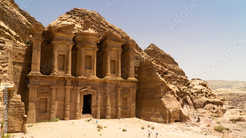 Stunning view of Ad Deir – the Monastery hidden between rocky hills of of Prehistoric Rock Carved City of Petra, Jordan