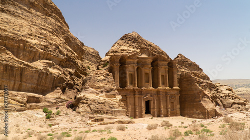 Stunning view of Ad Deir – the Monastery hidden between rocky hills of of Prehistoric Rock Carved City of Petra, Jordan