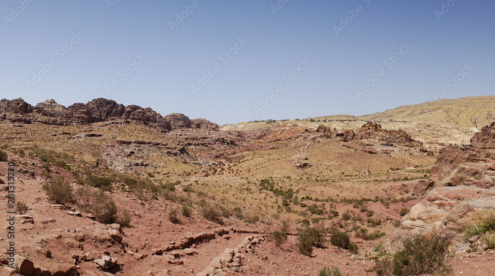 View of rocky hills and mountains in prehistoric rock carved city Petra, UNESCO World Heritage, the capital of the kingdom of the Nabateans in ancient times, Jordan. View of rocky hills and mountains in prehistoric rock carved city Petra, UNESCO World Heritage, the capital of the kingdom of the Nabateans in ancient times, Jordan.